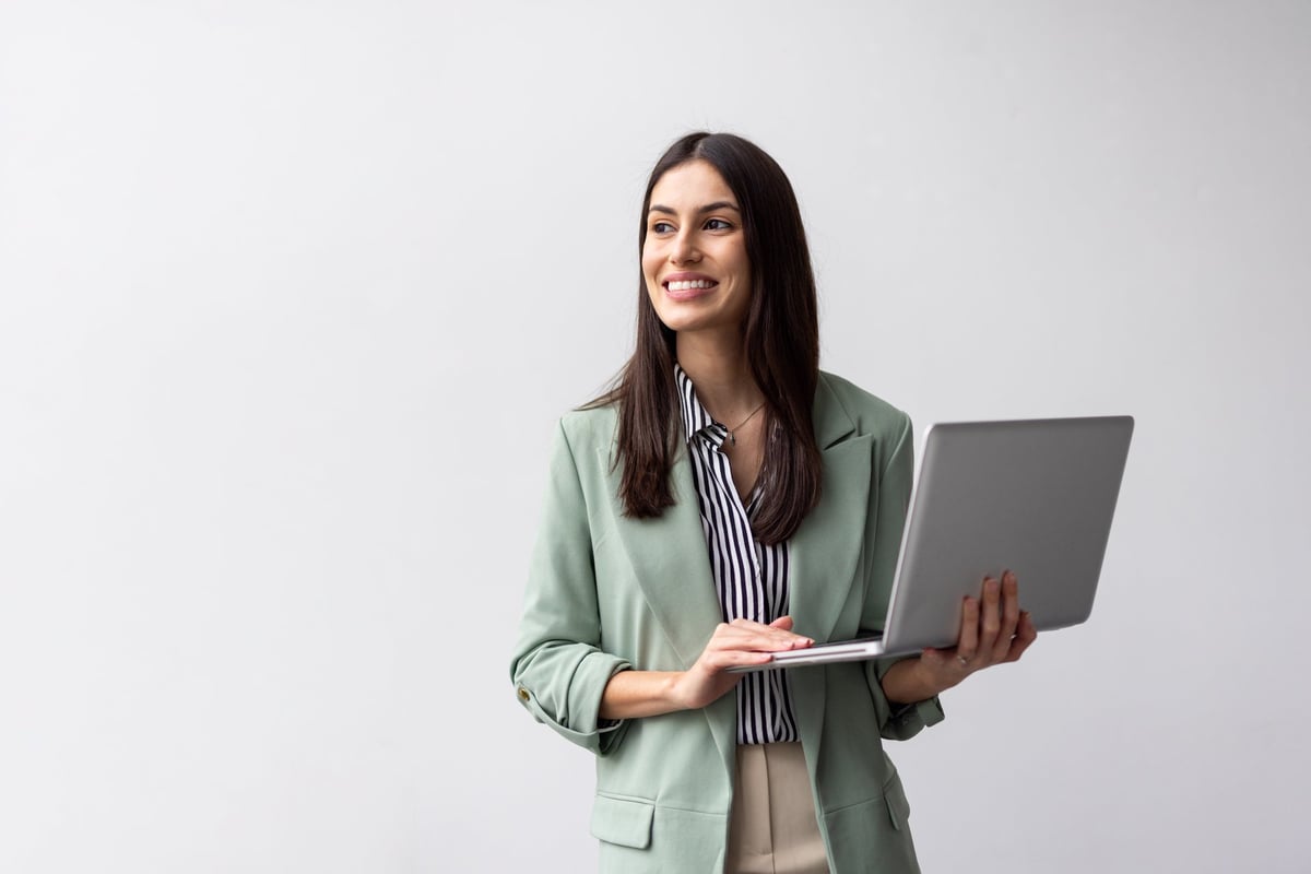Latina entrepreneur reviewing business reports on laptop