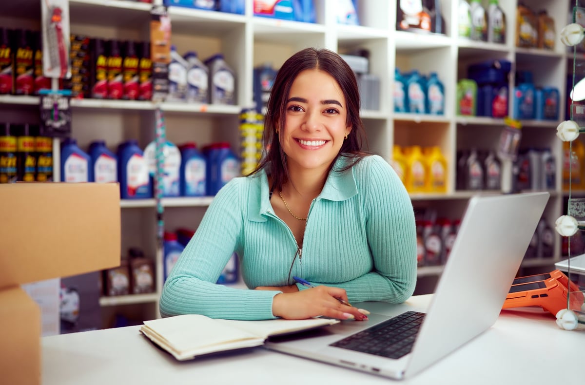 Cheerful young entrepreneur managing her digital business
