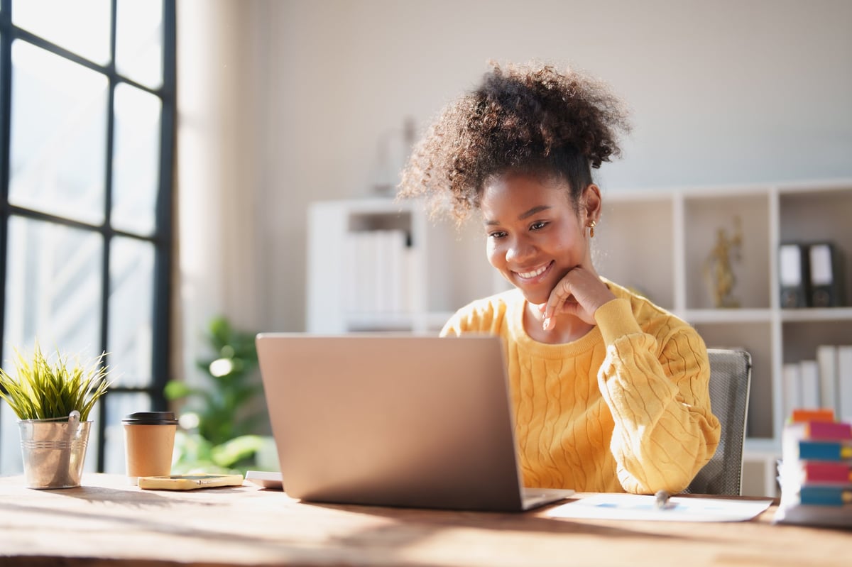 African American woman working from bright modern home office space